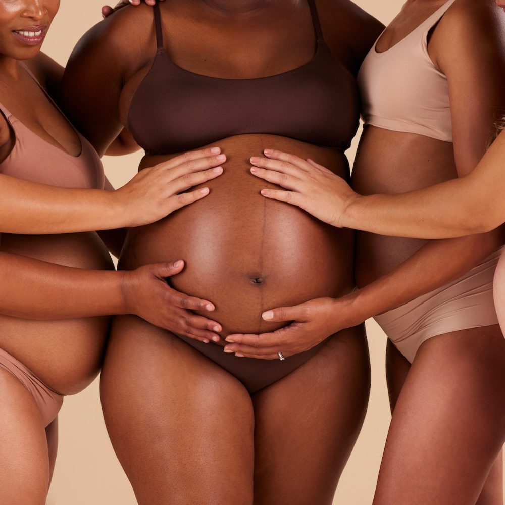 Women, hands or touching pregnancy belly of black woman on studio background in growth support, lov